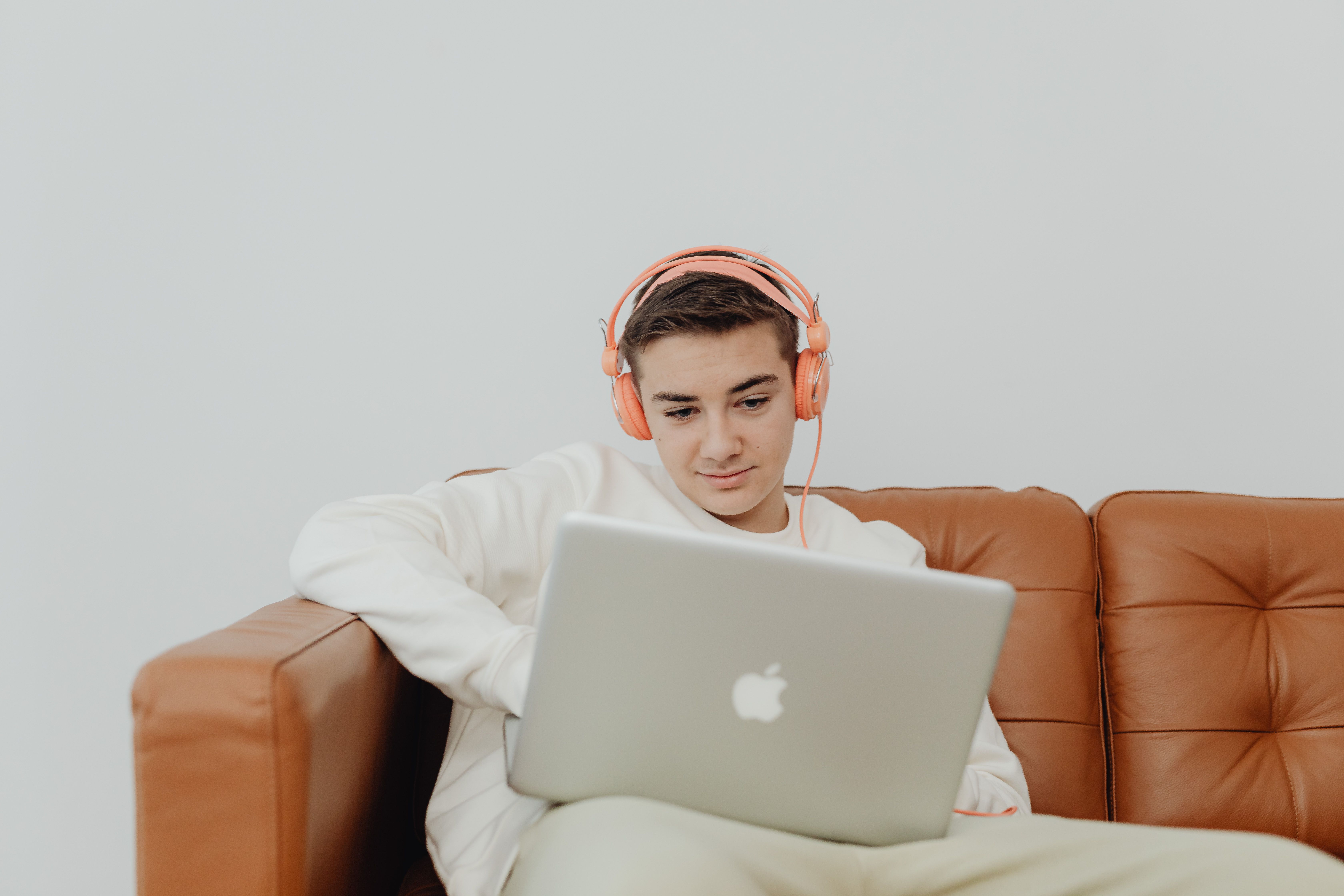 Teen learner with headphones and a laptop